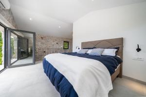 a bedroom with a large bed and a large window at Hideaway Stonehouse pool for 2 Dalmatia Imotski in Medvidovići +67 photos