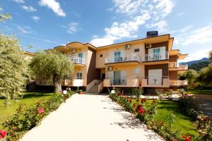 a large apartment building with a driveway at Chrisa Hotel in Limenas