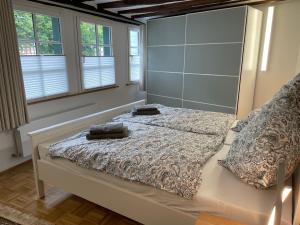 a bedroom with a bed with two pillows on it at Ferienhaus Schröder OM 3 Altstadt in Monschau