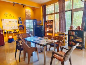 a dining room with a table and chairs at Devi music ashram in Rishīkesh