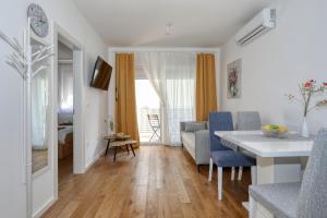 a kitchen and living room with a table and chairs at Charming sparcle in Dalmatia in Zadar