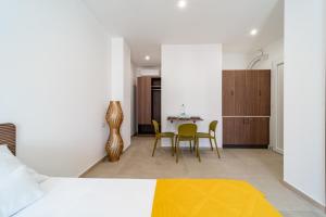 a bedroom with a table and chairs in a room at Costamar Vacanze in Lido Marini