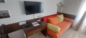 a room with a couch and a flat screen tv at Apartment Sansimon in Izola