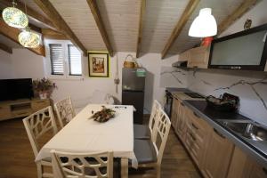 Polisi i VogëlにあるApartments by Elmar Villa at Sunset Bayのテーブルと椅子と冷蔵庫のあるキッチン