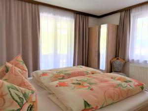 A bed or beds in a room at Apartment in Mayrhofen with a balcony