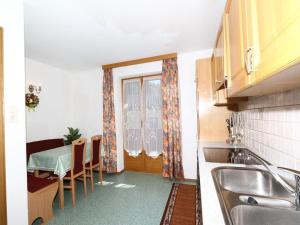 A kitchen or kitchenette at Apartment in Mayrhofen with a balcony