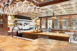 a large kitchen with wooden floors and chandeliers at Villa Coffee House in Palm Springs