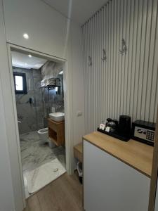 a bathroom with a shower and a sink and a toilet at Ilio Boutique Hotel in Ksamil