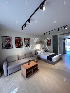 a living room with a bed and a couch at For Rent Modern Stylish Cabana at Hacienda Bay, North Coast, Egypt in El Alamein