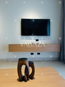 a living room with a tv and a pair of shoes at For Rent Modern Stylish Cabana at Hacienda Bay, North Coast, Egypt in El Alamein