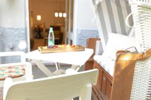 a table and chairs with a bowl of fruit on it at Reede 5 in Wangerooge +19 photos