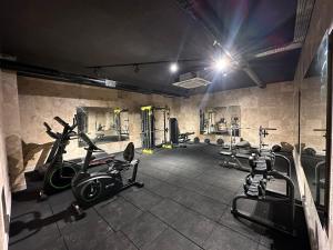 a gym with several treadmills and exercise bikes at RUBİN Residence in Alanya