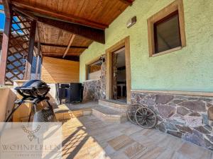 a home with a stone porch with a bike parked on a patio at Wohnperle Bauernhaus Meusegast in Dohna