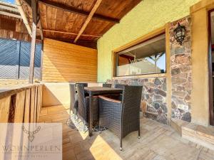 a patio with a table and a stone wall at Wohnperle Bauernhaus Meusegast in Dohna +57 photos
