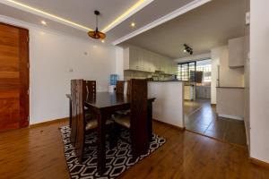 a kitchen with a table in the middle of a room at Erica Residences - Riverside in Nairobi