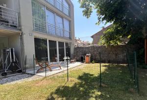 a yard with a playground in front of a building at Monolocale con giardino in Villa Opicina
