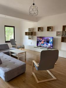 a living room with a couch and a tv at Casa Livia in Tuzla