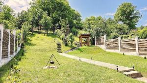 a garden with a fence and a swing at Iosif 55 in Sighişoara