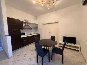 a kitchen and dining room with a table and chairs at SN VistaMare in Lido di Classe