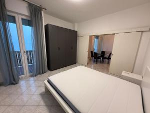 a bedroom with a large bed and a dining room at SN VistaMare in Lido di Classe