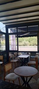 a room with tables and chairs and a large window at Port Hotel, Tasucu in Silifke