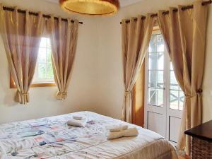 a bedroom with a bed and a window at Quinta de S. Vicente 317 in Vila Nova de Famalicão +99 photos