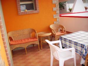 a dining room with chairs and a table and a table and chairsktop at Finestra sul mare in Calabernardo +9 photos