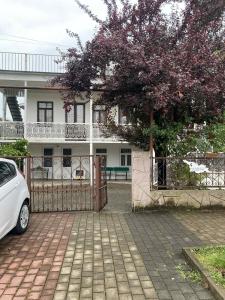 a white car parked in front of a house at tata's house in K'obulet'i +39 photos