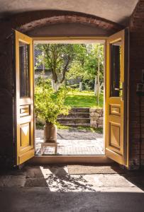 an open door with a potted plant in the doorway at Wietorówka in Lubomierz +59 photos