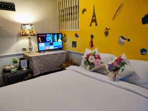 a bedroom with a white bed with flowers on it at mstay in Bangkok