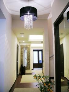 a hallway with a chandelier in a building at Cassisi Hotel in Milazzo