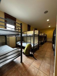 a room with a bunch of bunk beds in it at Albergue de peregrino Cruz de Fierro in Foncebadón