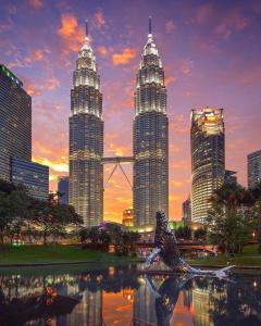 a city skyline with tall skyscrapers and a bridge at AQ Hotel Kuala Lumpur in Kuala Lumpur +22 photos