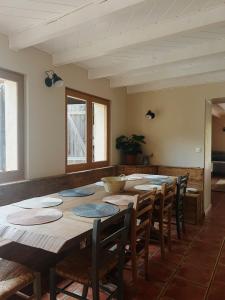 a room with a large wooden table and chairs at La Casa d'Opale, maison de vacances 14 couchages in Montauban