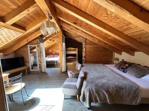 a bedroom with a large bed in a cabin at Hôtel-Chalet les Mélèzes in Valloire