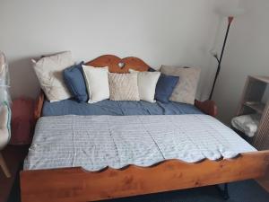 un letto con cuscini blu e bianchi di Maison pétanque piscine 2 à 6 personnes a Chevigny-en-Valière Altre 18 foto