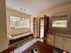 a living room with a bed and a kitchen at The Big Olive Tree in Hanioti