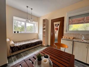 a room with a bench in the middle of a kitchen at The Big Olive Tree in Hanioti +28 photos
