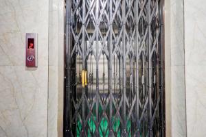 a door with a metal gate in a building at Townhouse Warangal Central Station in Warangal