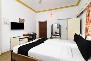 a hotel room with a bed and a television at Hotel O Salt lake City in Kolkata