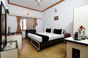 a hotel room with a bed and a desk at Hotel O Salt lake City in Kolkata