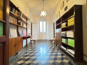 a room with two chairs and book shelves at casa vacanze La Versilia in Vallecchia