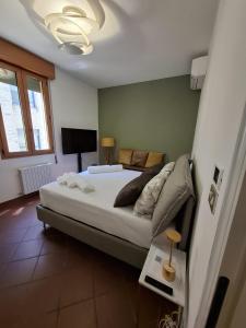 una camera da letto con un letto grande e una televisione di Le Due Torri Sotto Casa a Bologna