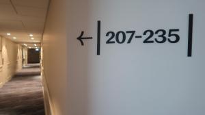 a hallway of an office building with numbers on the wall at Home Hotel Fregatten in Varberg