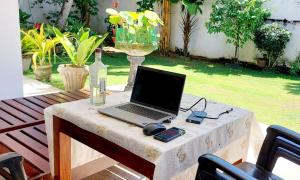 a laptop computer sitting on a table on a patio at Villa Serenity Weligama in Weligama +60 photos