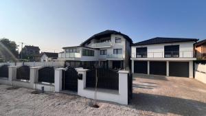 a large white house with a gate in front of it at White house Paradise in Bihać