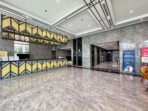 a large lobby with a large marble floor in a building at Alinea Suites in Shah Alam +13 photos