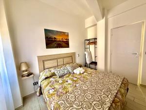 a bedroom with a bed with a stuffed animal on it at Maison du port 2 in Civitavecchia