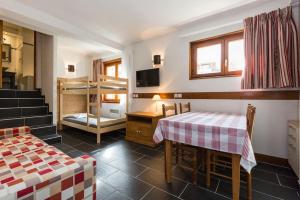 a small room with a table and a bunk bed at Les Aiguilles de Warens - Combloux in Combloux +87 photos