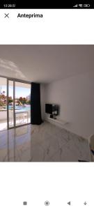 a picture of a living room with a tv on a wall at Maria Luxury Apartament Golf del Sur Tenerife in San Miguel de Abona